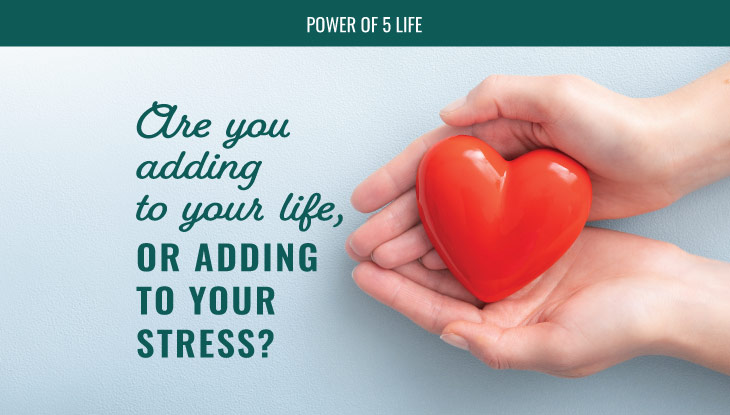 hands holding a heart-shaped stress ball in a blog post about are you adding to your life or to your stress