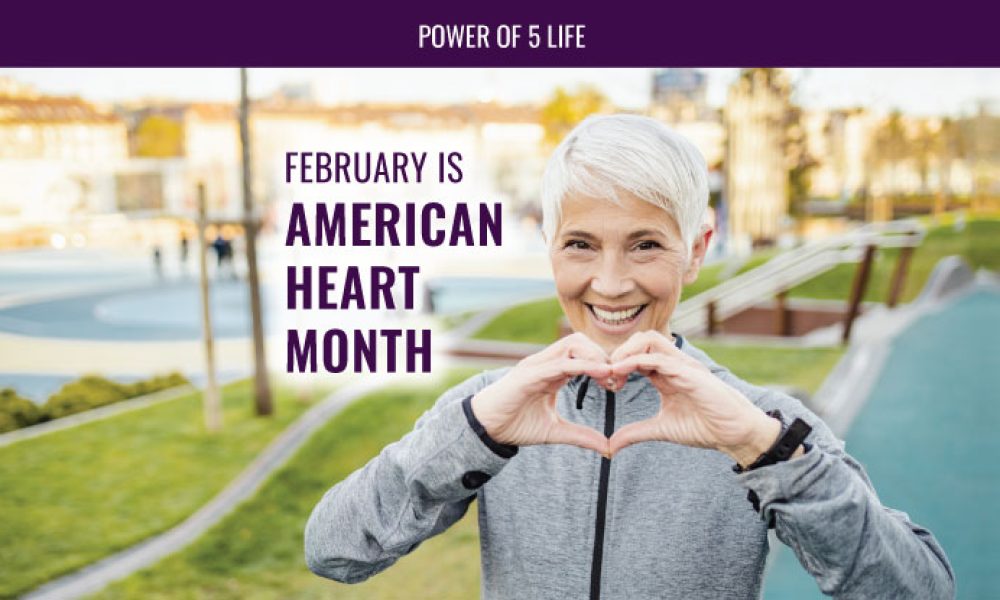 February is American Heart Month & a woman with her hands in the shape of a heart