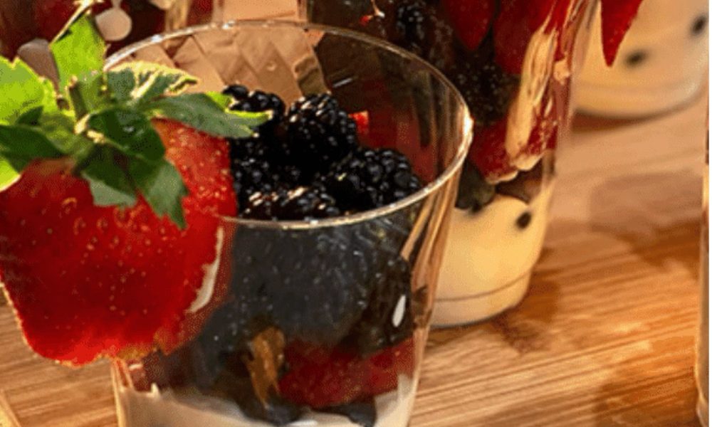 yogurt parfait with berries and dark chocolate drizzle