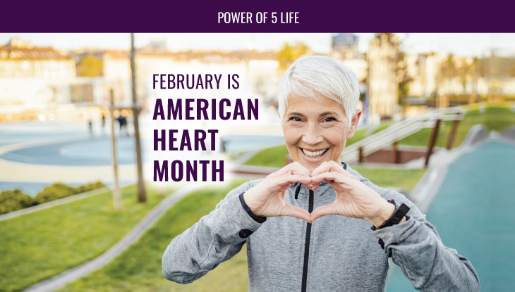 February is American Heart Month & a woman with her hands in the shape of a heart